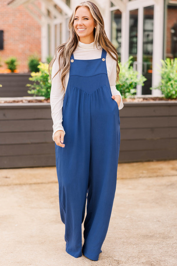 Chic Soul plus size clothing, denim colored jumpsuit with buttoned detail on the straps and pleats and functional pockets