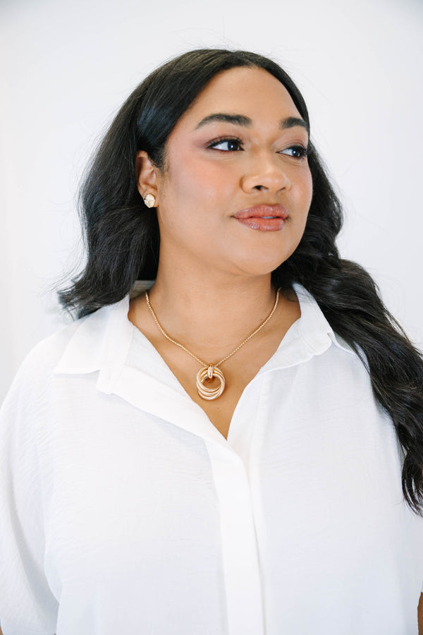 Plus Size gold necklace with three interlocking textured circles on a delicate chain.