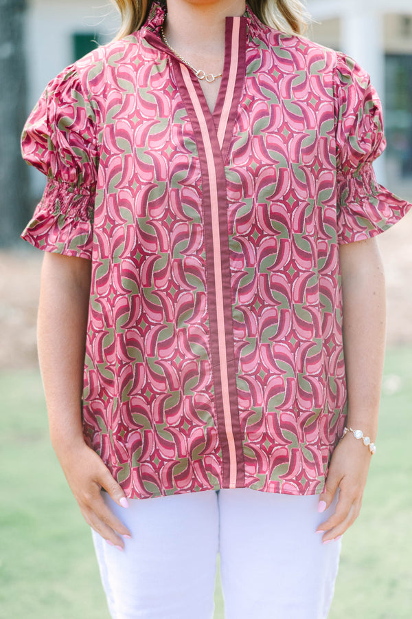 Plus Size wine-colored cotton top with a geometric pattern, V-neckline, and puffed short sleeves.