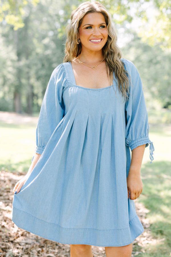 Plus Size light blue denim-look dress with a square neckline, pleated bodice, and puff sleeves.