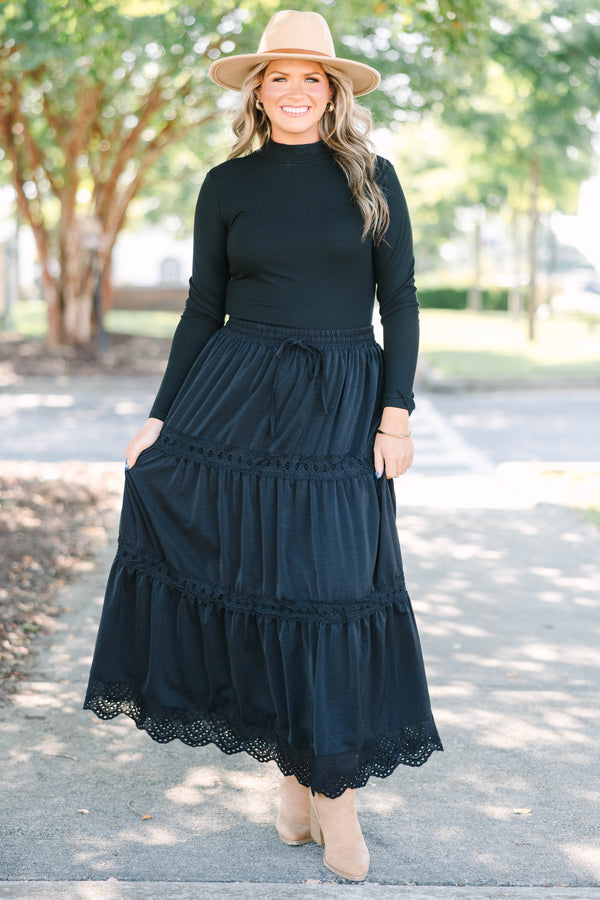 Plus size black tiered maxi skirt with lace trim, smocked waist, and flowy silhouette.