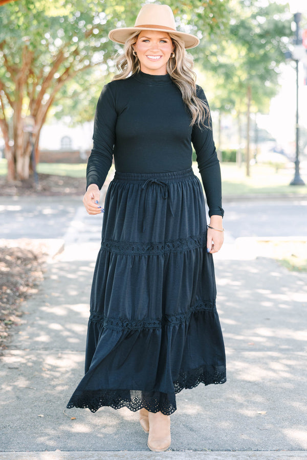 Plus size black tiered maxi skirt with lace trim, smocked waist, and flowy silhouette.