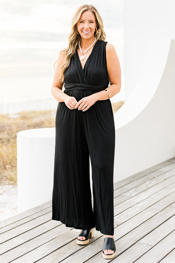 Chic Soul plus size clothing, black sleeveless jumpsuit with wide leg and tie waist detail with v neckline and tie detail on the back with pockets