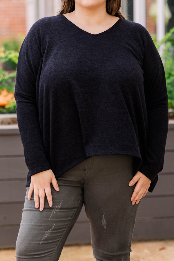 Plus Size long sleeve black top with a v-neckline and a relaxed, oversized fit.