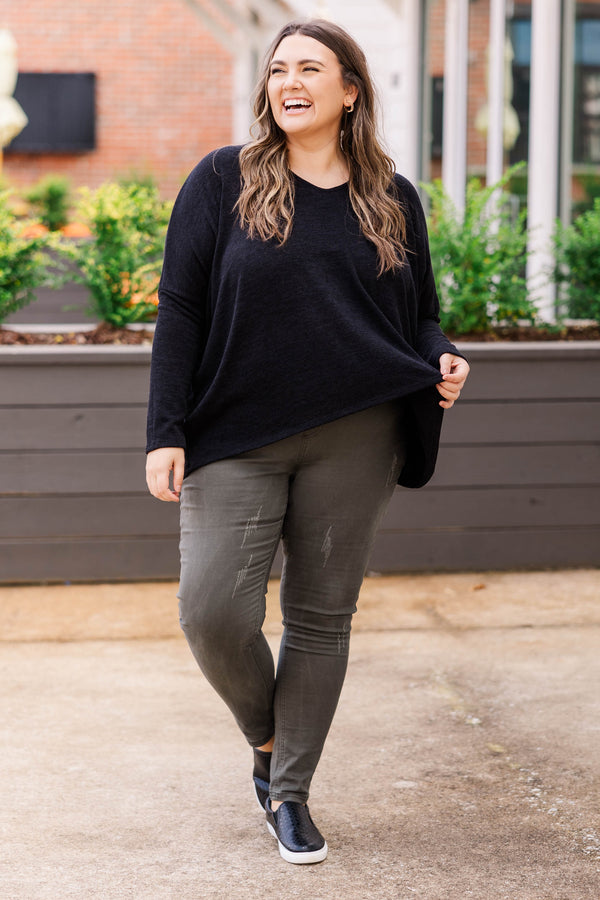 Plus Size long sleeve black top with a v-neckline and a relaxed, oversized fit.