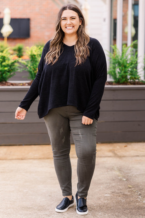 Plus Size long sleeve black top with a v-neckline and a relaxed, oversized fit.