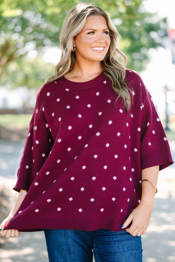 Plus size burgundy polka dot sweater with a relaxed fit, crew neck, and soft knit fabric.