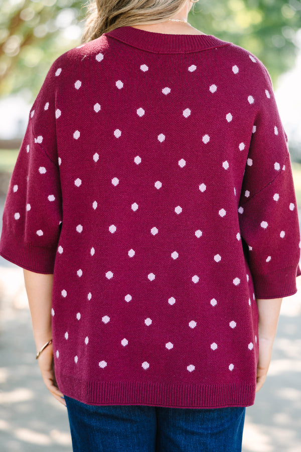 Plus size burgundy polka dot sweater with a relaxed fit, crew neck, and soft knit fabric.