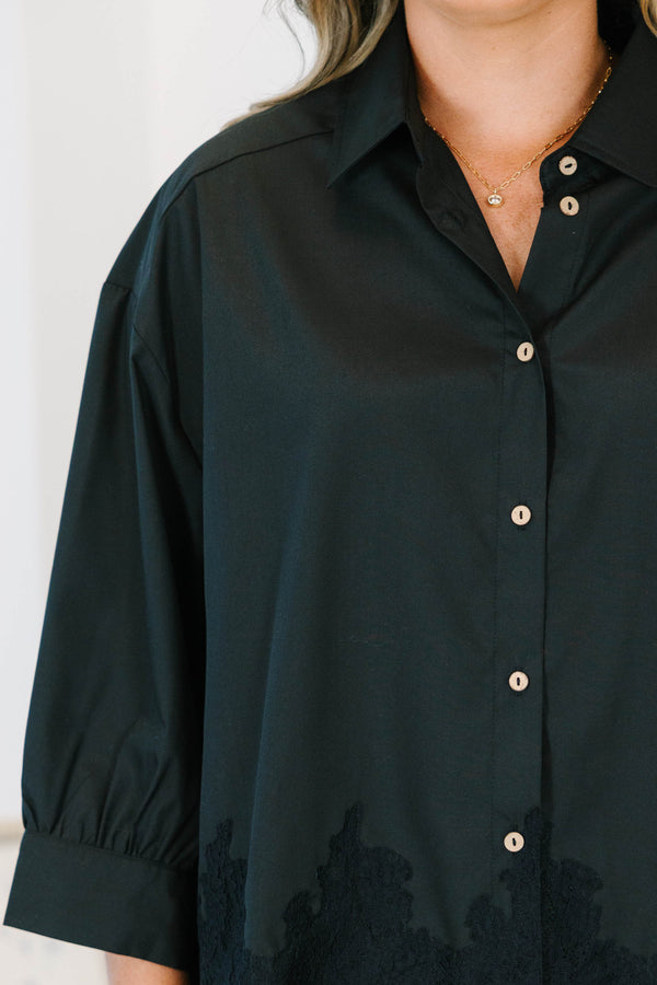 Plus size black button-down top with a flowy fit and delicate lace hem detail.
