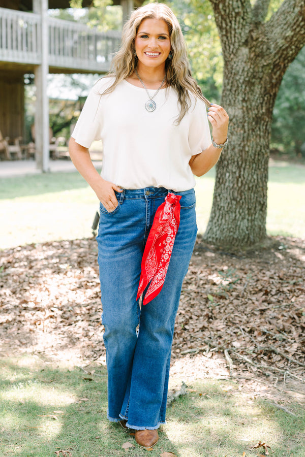 Plus size medium wash flare jeans with a raw hem and stretchy denim for a confident, flowy fit.