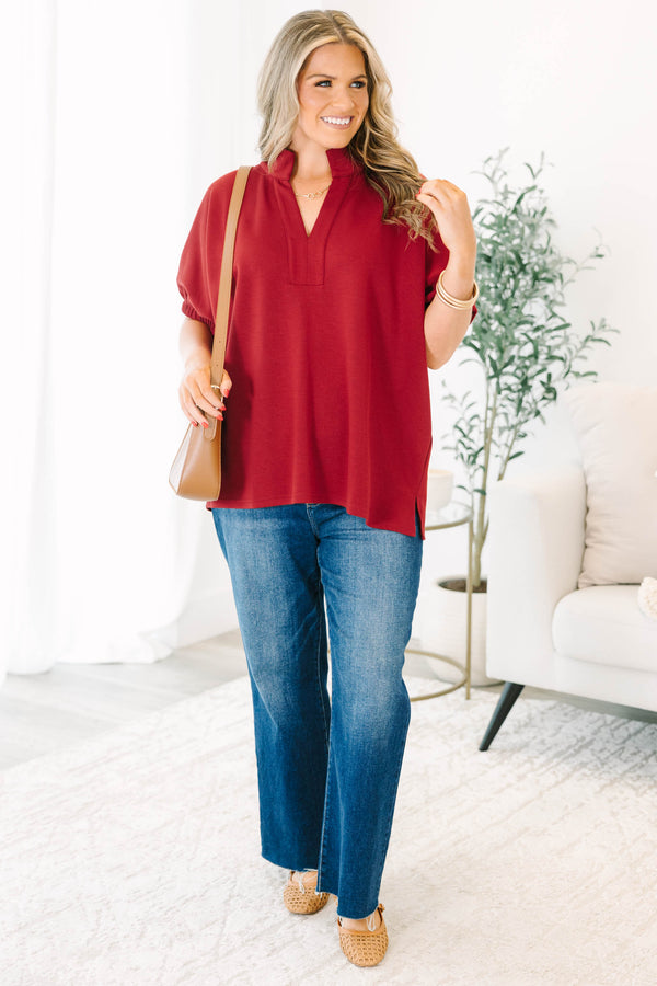 Plus Size cabernet red top with a v-neckline, relaxed fit, and short elasticized sleeves.