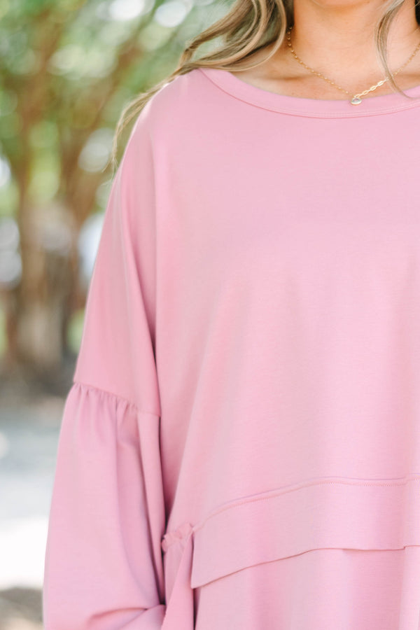 Plus size pink cotton top with a flowy tiered ruffle hem and voluminous puff sleeves.