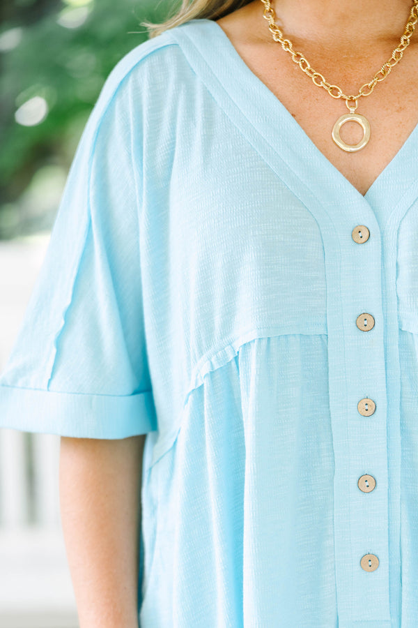 Plus Size aqua romper with a V-neckline, functional front buttons, short sleeves, and side pockets.