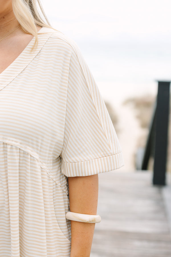 Chic Soul plus size clothing,  brown striped romper with short sleeves that have cuffs at the end of them as well as a v-neckline and buttons going down the center of the chest to the bottom of the belly 
