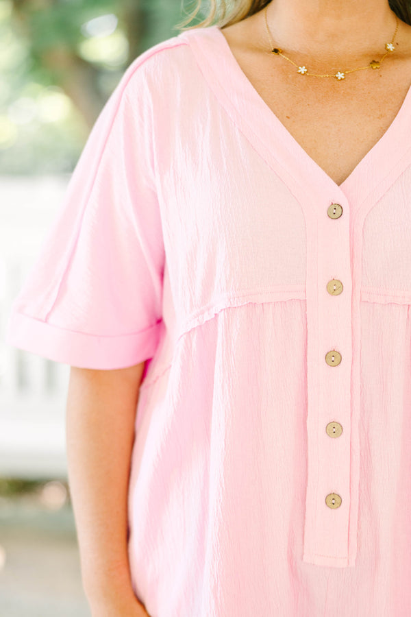Plus Size orchid pink short sleeve romper with a V-neckline and button-down front detail.