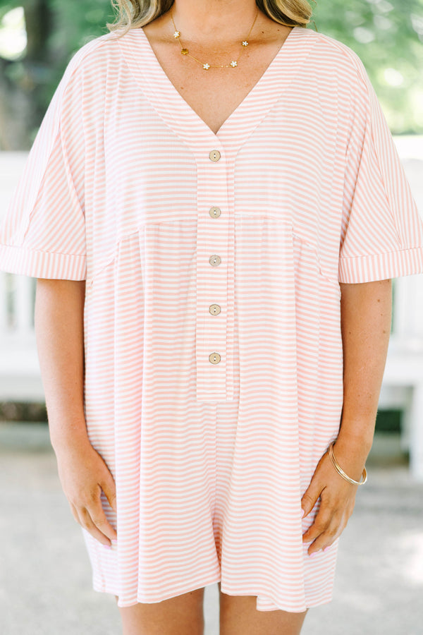 Plus size pink and white striped romper with a flowy fit, V-neck, and functional front buttons.