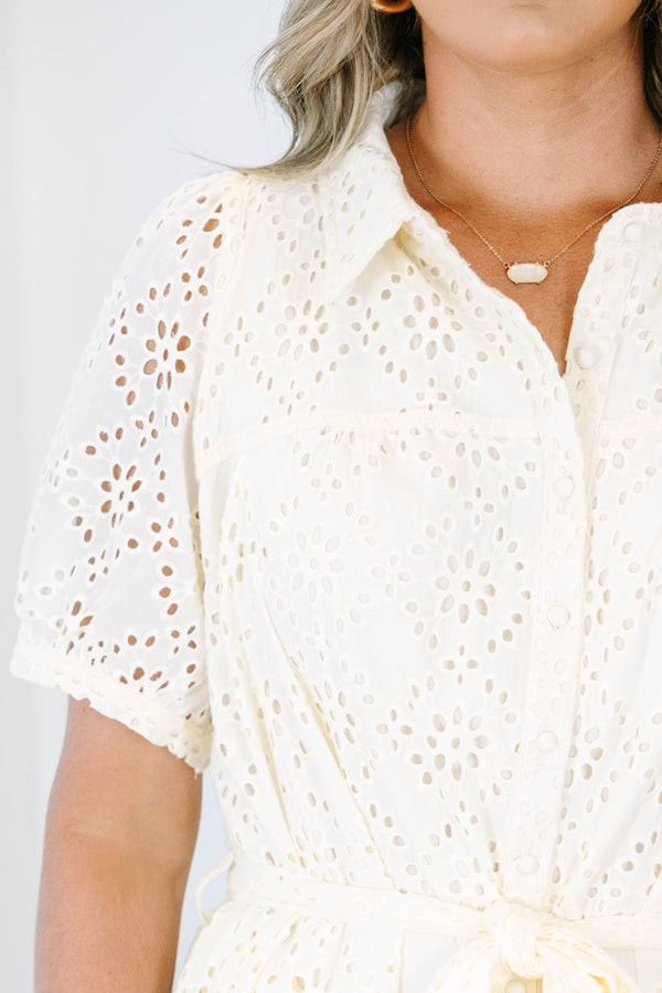 Plus size cream eyelet shirt dress with short puff sleeves and a tie waist for a flowy fit.