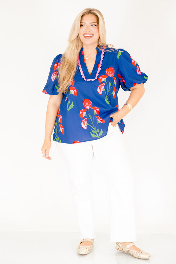 Chic Soul plus size clothing, blue top with short bubble sleeves a floral block pattern throughout and pink scalloped detailing outlining the v-neckline