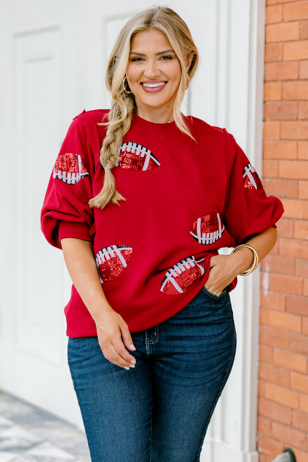 Chic Soul plus size clothing, red top with bubble sleeves that has red sparkly football patches throughout the shirt 