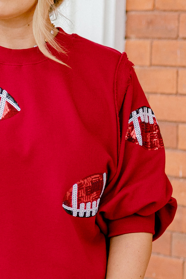 Chic Soul plus size clothing, red top with bubble sleeves that has red sparkly football patches throughout the shirt 