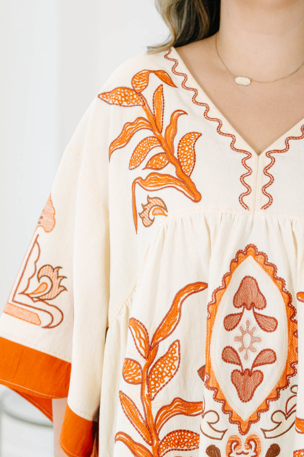 Plus size clothing, cream colored tunic top with orange embroidery