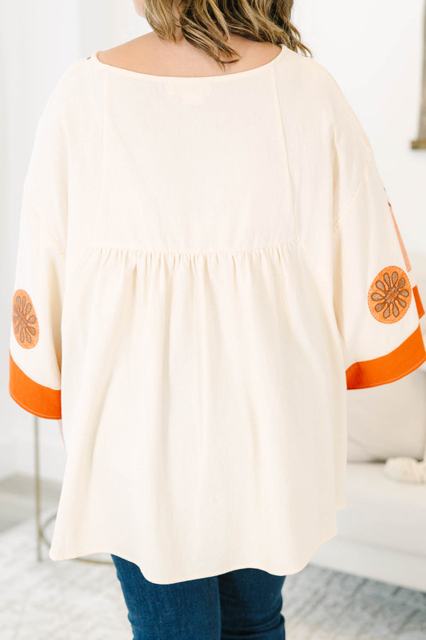 Plus size clothing, cream colored tunic top with orange embroidery
