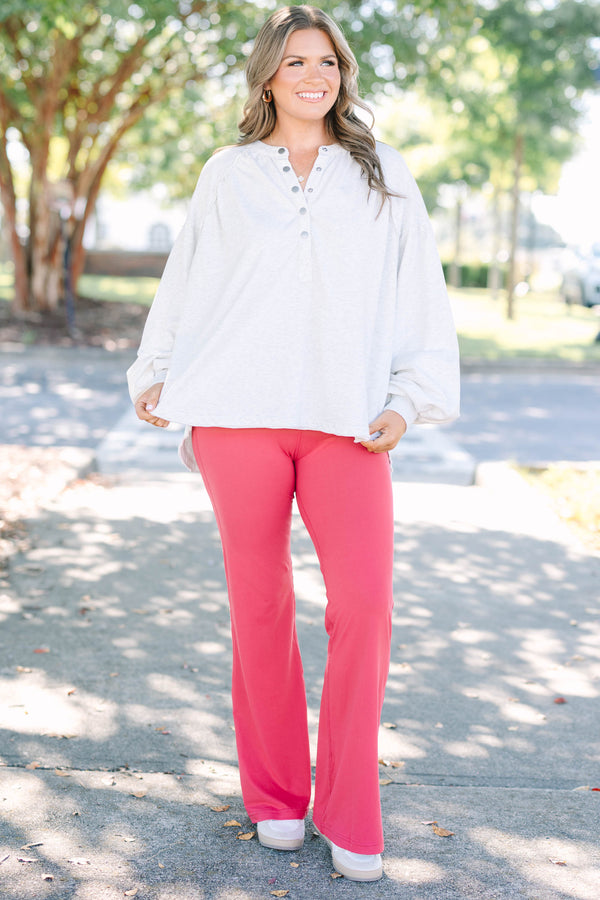Plus Size high-rise flare leggings in coral with a wide waistband and smooth, stretchy fabric.