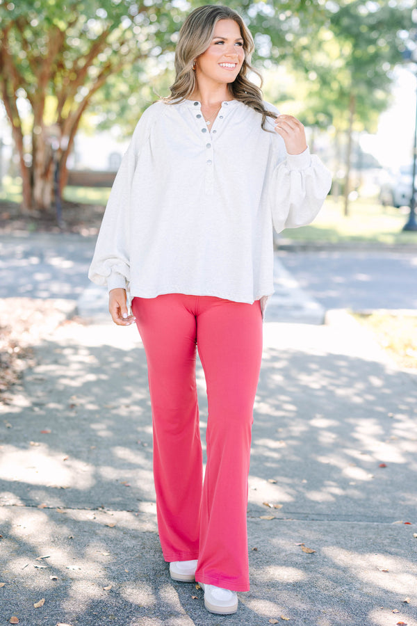 Plus Size high-rise flare leggings in coral with a wide waistband and smooth, stretchy fabric.