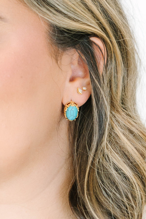 Turquoise Trails Earrings, featuring an oval turquoise stone in a gold-toned setting.