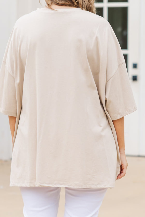 Plus Size light mocha oversized boyfriend tee with a USA star graphic and white pants.