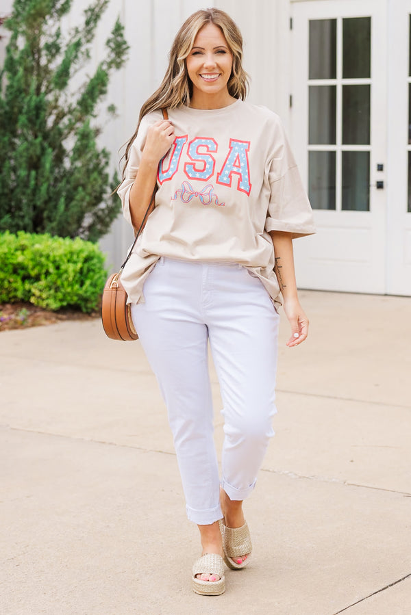 Plus Size light mocha oversized boyfriend tee with a USA star graphic and white pants.