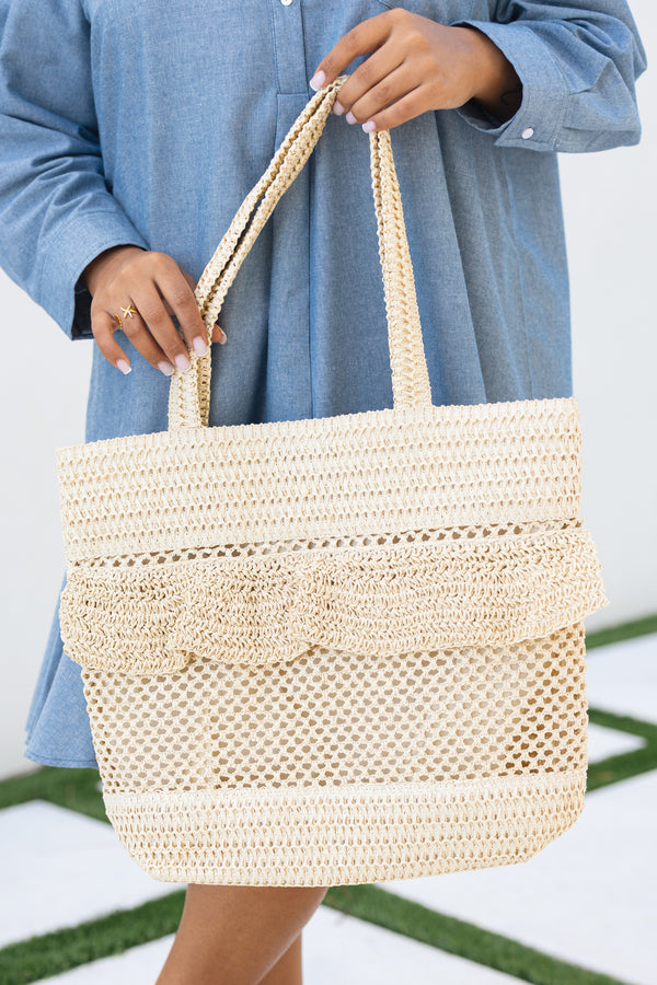 Chic Soul plus size clothing, beige woven bag with straps as well as a ruffle flap going around the top middle of the bag 