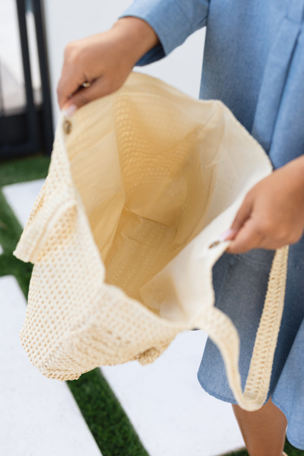 Chic Soul plus size clothing, beige woven bag with straps as well as a ruffle flap going around the top middle of the bag 