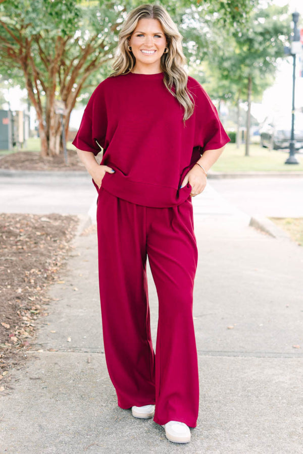 Plus Size red two-piece set with a ribbed short-sleeve crewneck top and matching wide-leg pants.