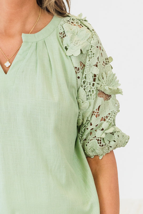 Chic Soul plus size clothing, short-puffed-sleeve sage green top with a split-v-neckline and floral lace detailing along the sleeve