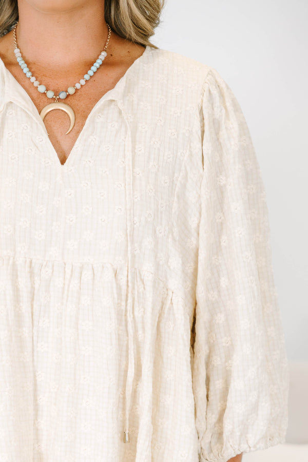 Plus Size cream babydoll dress with a V-neckline, tassel ties, and long balloon sleeves.