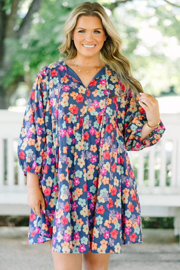 Plus size navy floral mini dress with a flowy fit, V-neckline, and three-quarter length sleeves.