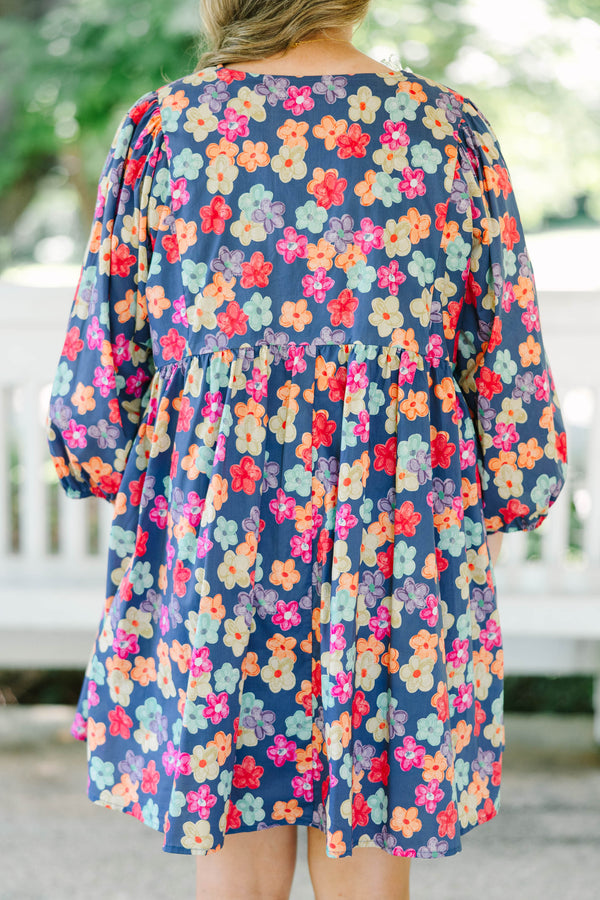 Plus size navy floral mini dress with a flowy fit, V-neckline, and three-quarter length sleeves.