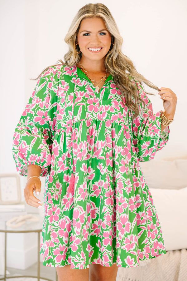 Plus size pink and green floral mini dress with flowy fit, long puff sleeves, and tassel ties.