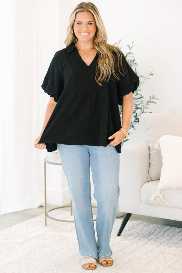 Plus size black cotton top with a flowy fit, smocked bodice, and puff sleeves.