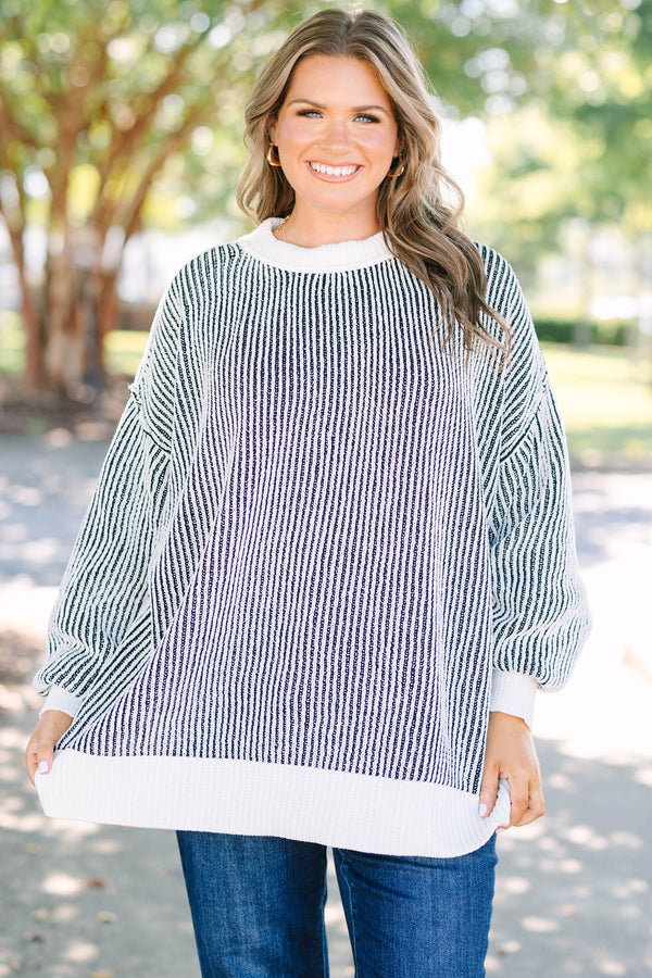 Plus Size oversized black and white vertical striped knit sweater with a crew neck and ribbed trim.