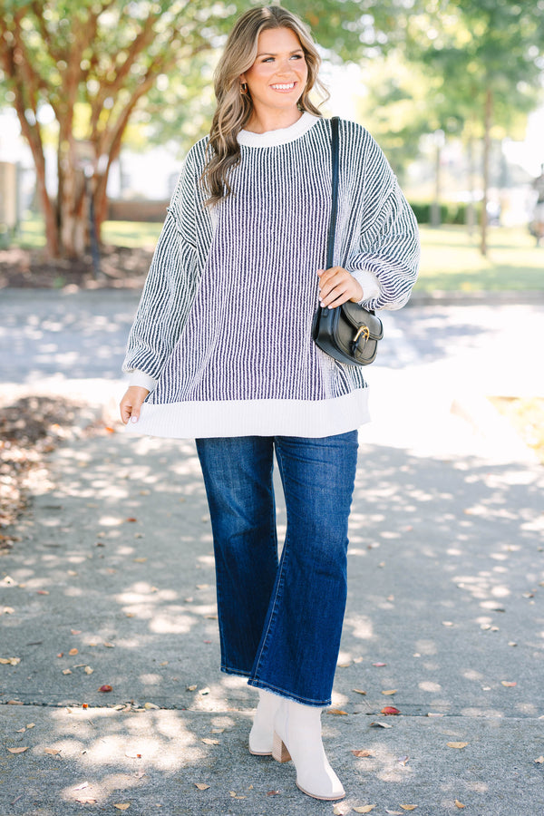 Plus Size oversized black and white vertical striped knit sweater with a crew neck and ribbed trim.