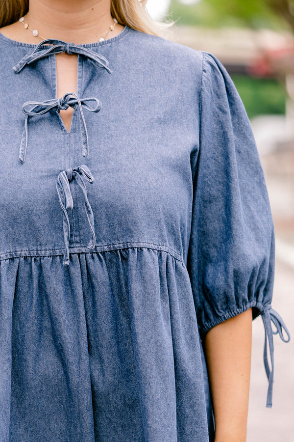 Chic Soul plus size clothing, denim blue short-sleeve short dress that has sleeves tied with bows and a bow tied detailing on the top