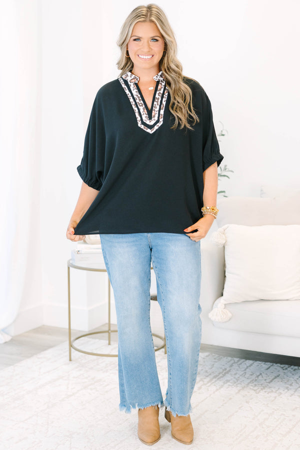 Plus Size black short dolman sleeve top with a leopard print split v-neckline trim.