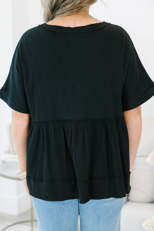 Plus size black cotton-blend babydoll top with button-front detail and a flowy tiered silhouette.