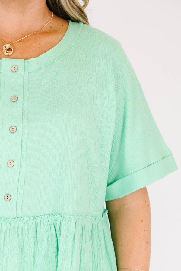 Chic Soul plus size clothing, short-sleeve vibrant green baby doll top with a high-scoop-neckline and brown button detailing with subtle distressed detailing 