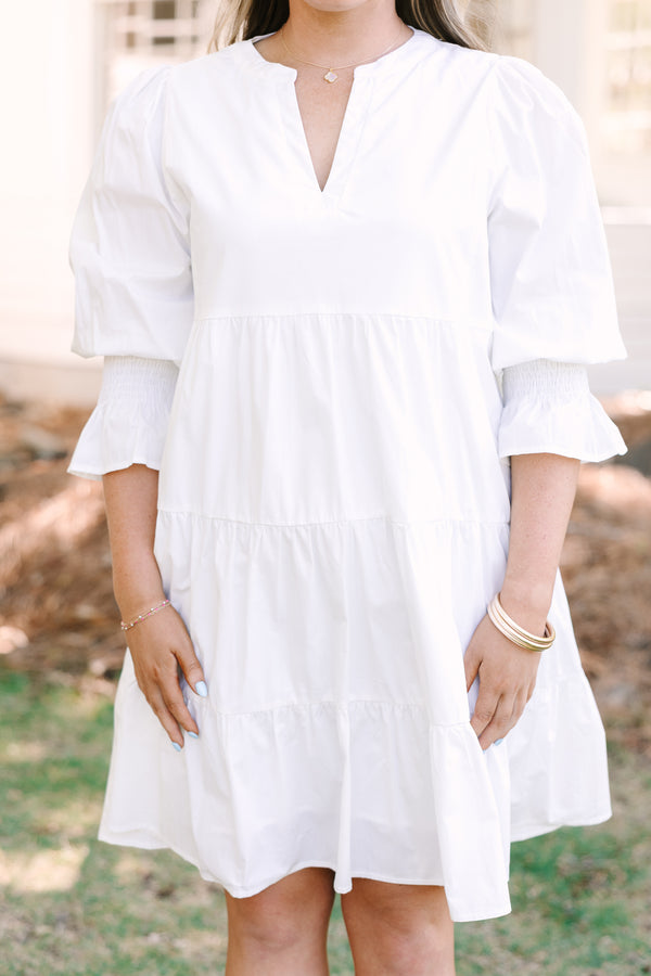 Plus Size white babydoll dress with a split v-neck, smocked cuffs, and mini bell sleeves.