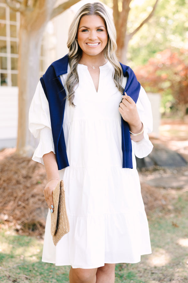 Plus Size white babydoll dress with a split v-neck, smocked cuffs, and mini bell sleeves.