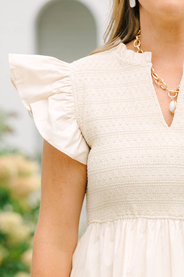 Plus size cream midi dress with ruffle sleeves, a smocked bodice, and a flowy tiered skirt.