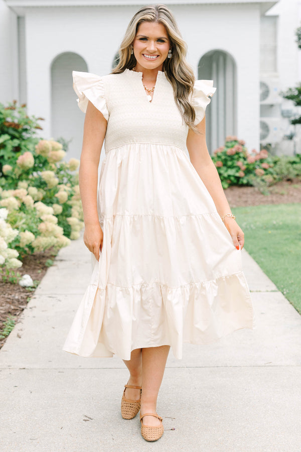 Plus size cream midi dress with ruffle sleeves, a smocked bodice, and a flowy tiered skirt.